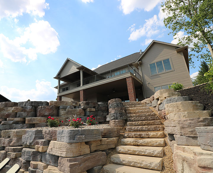 stone steps and ledge to river from backyard